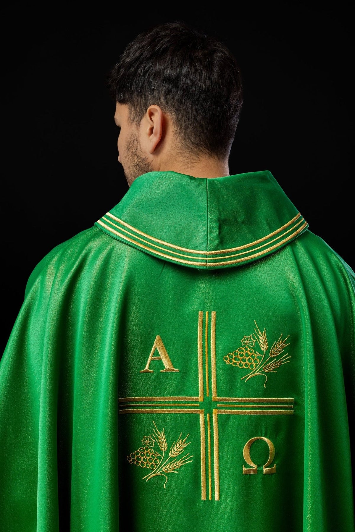 Green chasuble back close-up with gold trim and embroidery