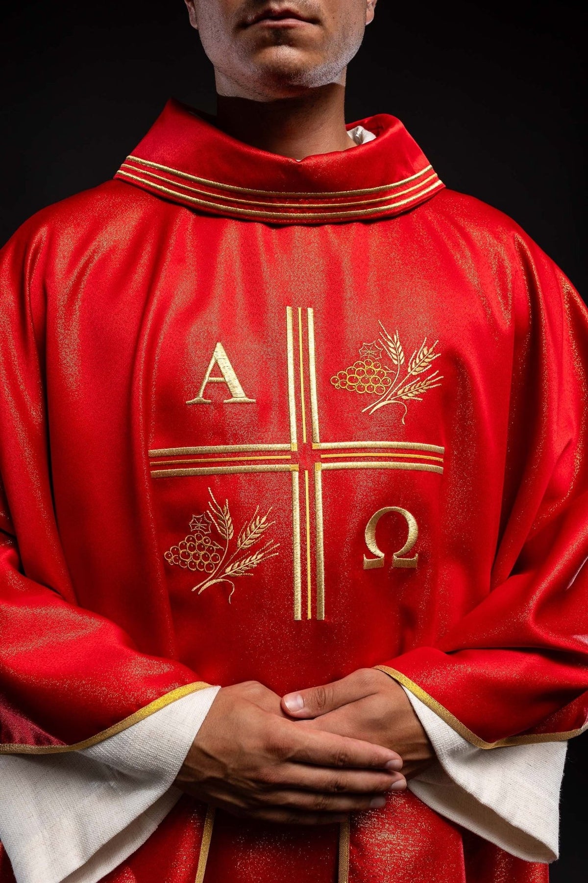 Red chasuble, close-up front view of gold embroidered cross, Alpha Omega and wheat motifs