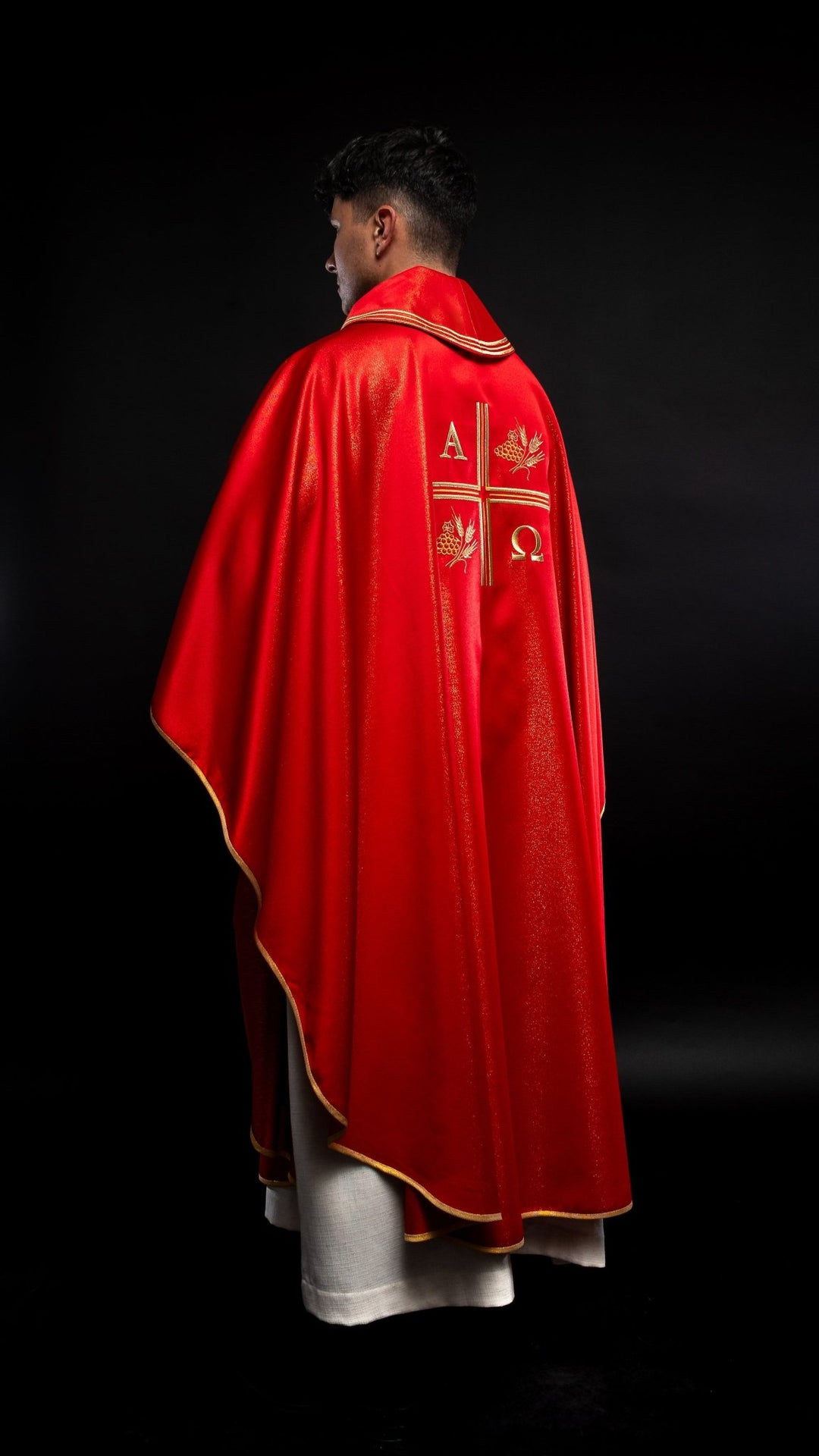 Red chasuble, side view showing gold trim and embroidered back motifs