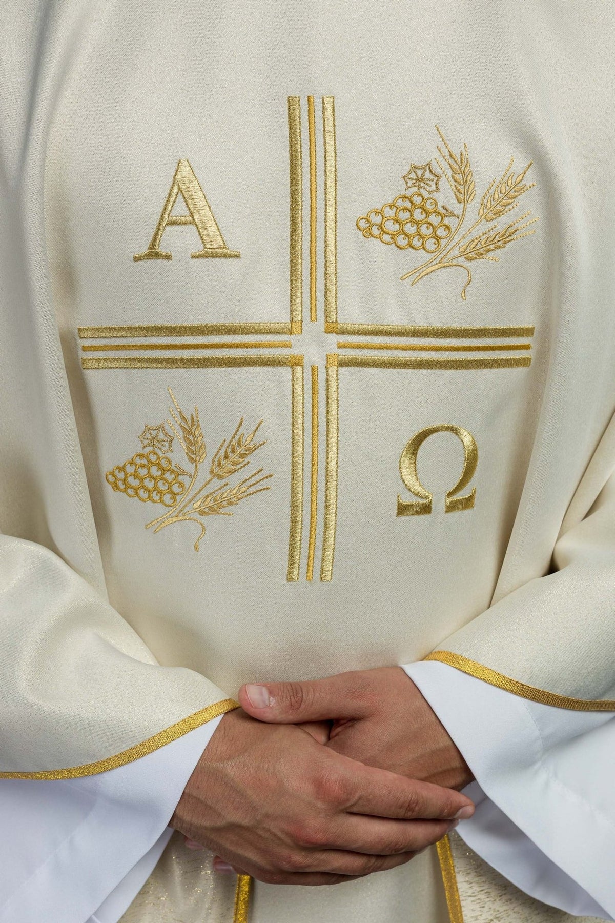 Ecru chasuble front close-up showing embroidered cross, Alpha Omega, and wheat motifs