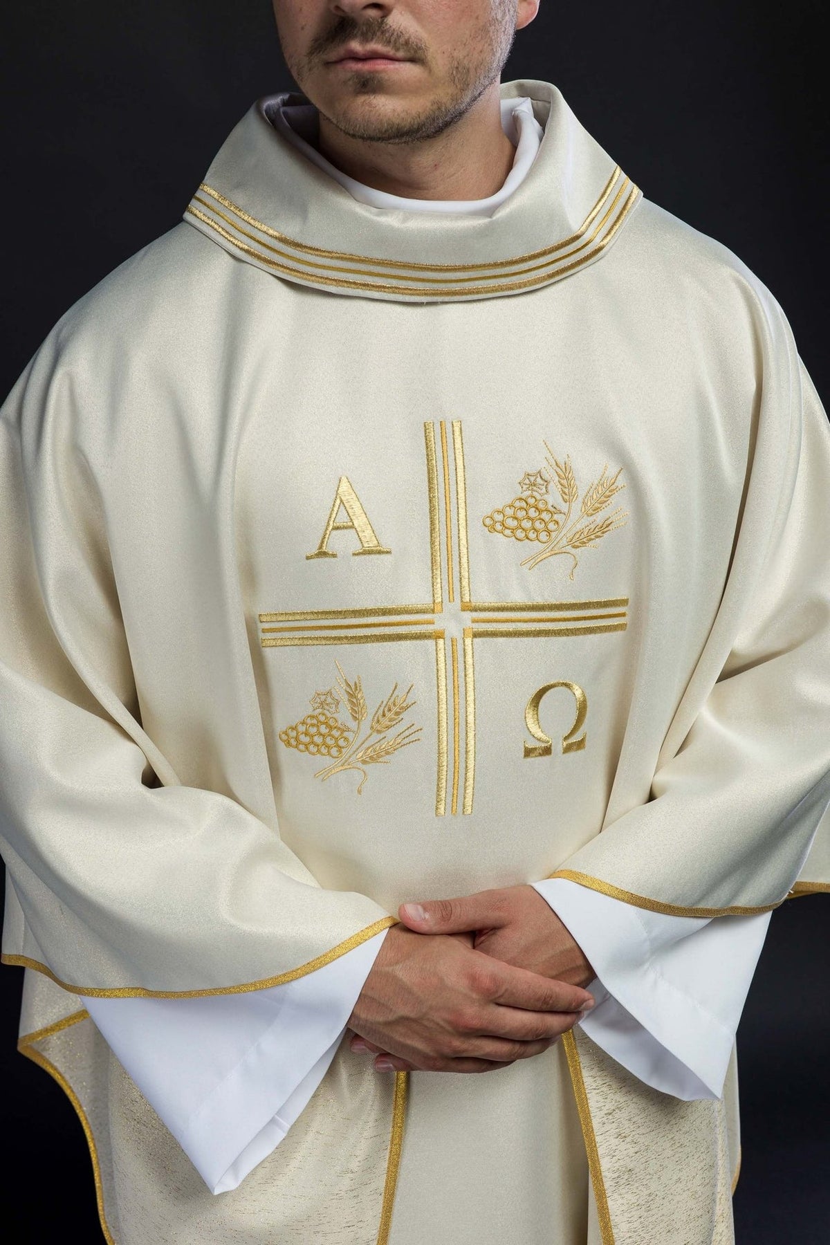 Ecru chasuble front detail showing gold-trimmed collar and embroidered motifs