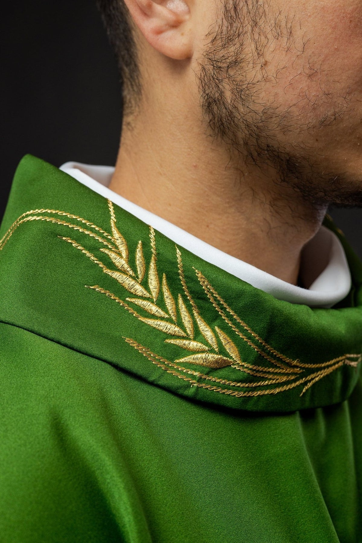Green chasuble collar close-up with gold wheat embroidery