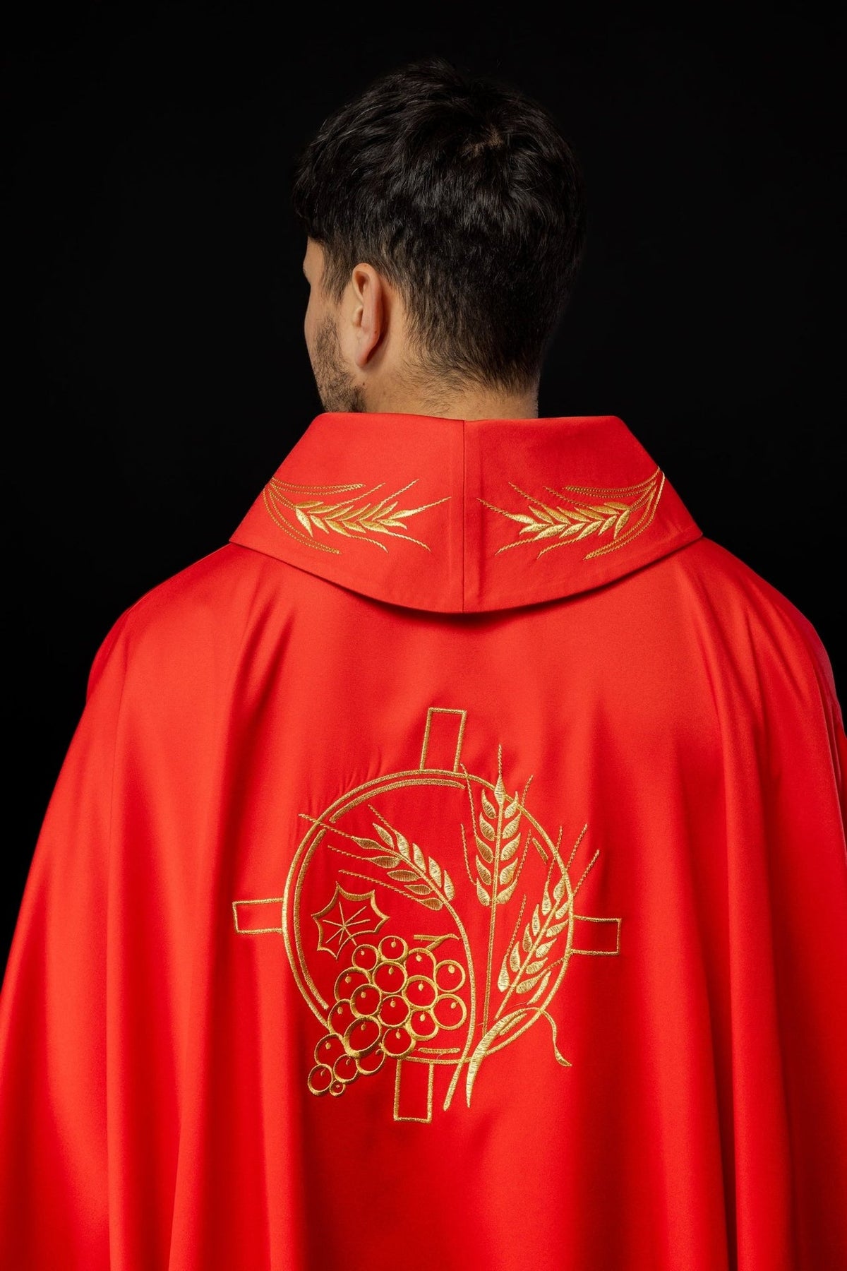Red chasuble back view with embroidered wheat motifs on the collar and cross