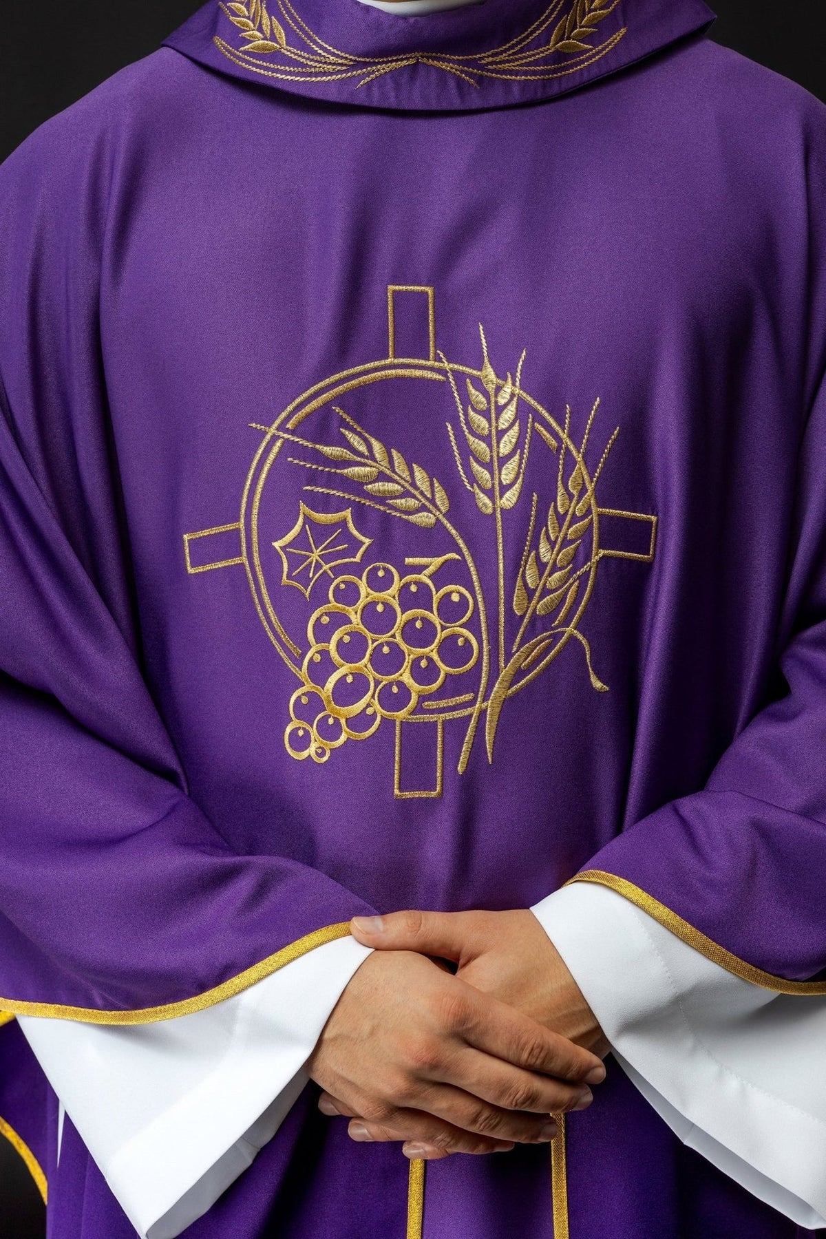 Purple chasuble close-up showing gold cross, wheat and grape embroidery