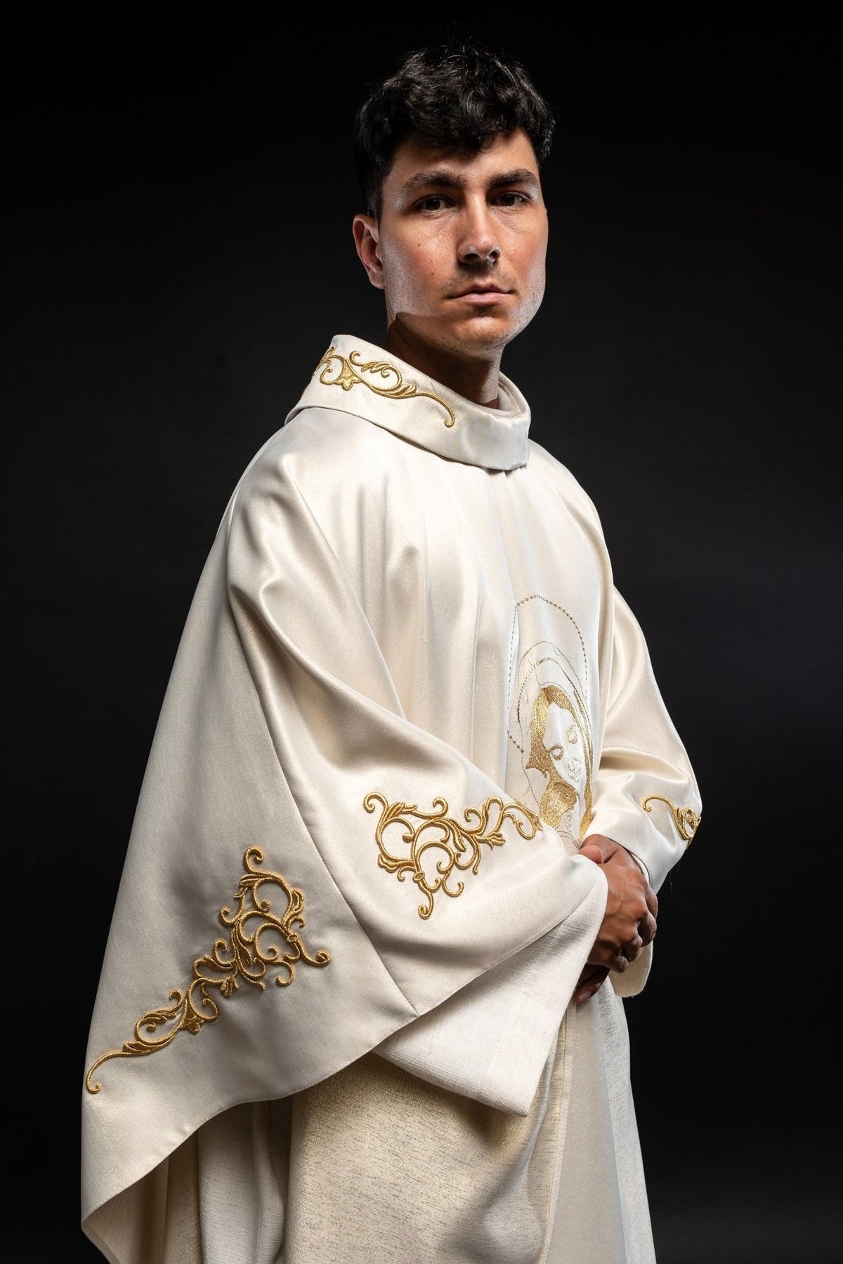 Liturgical chasuble side view showing gold embroidery on the sleeve and stand-up collar