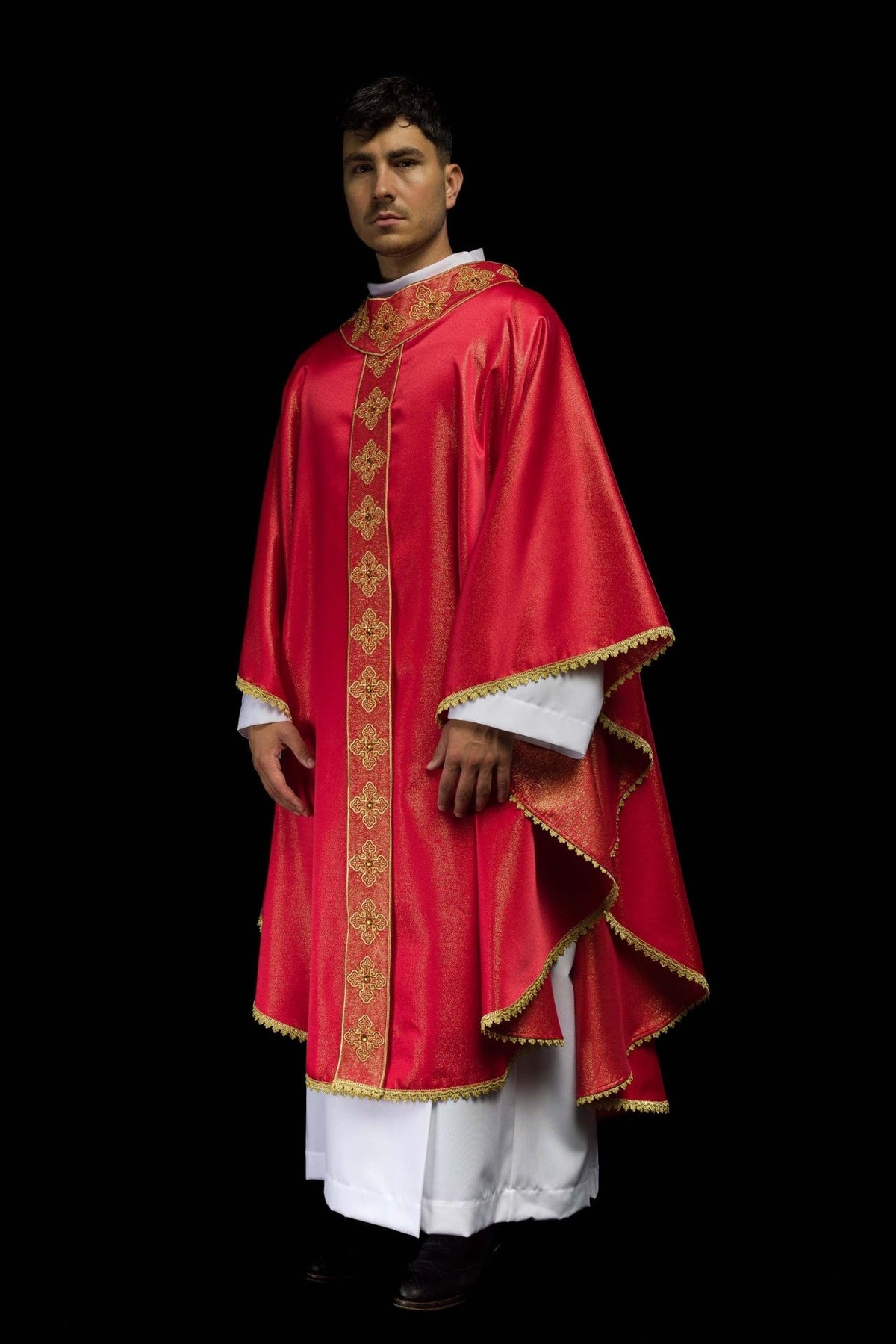Red chasuble, side view showing gold embroidered orphrey and trimmed edges