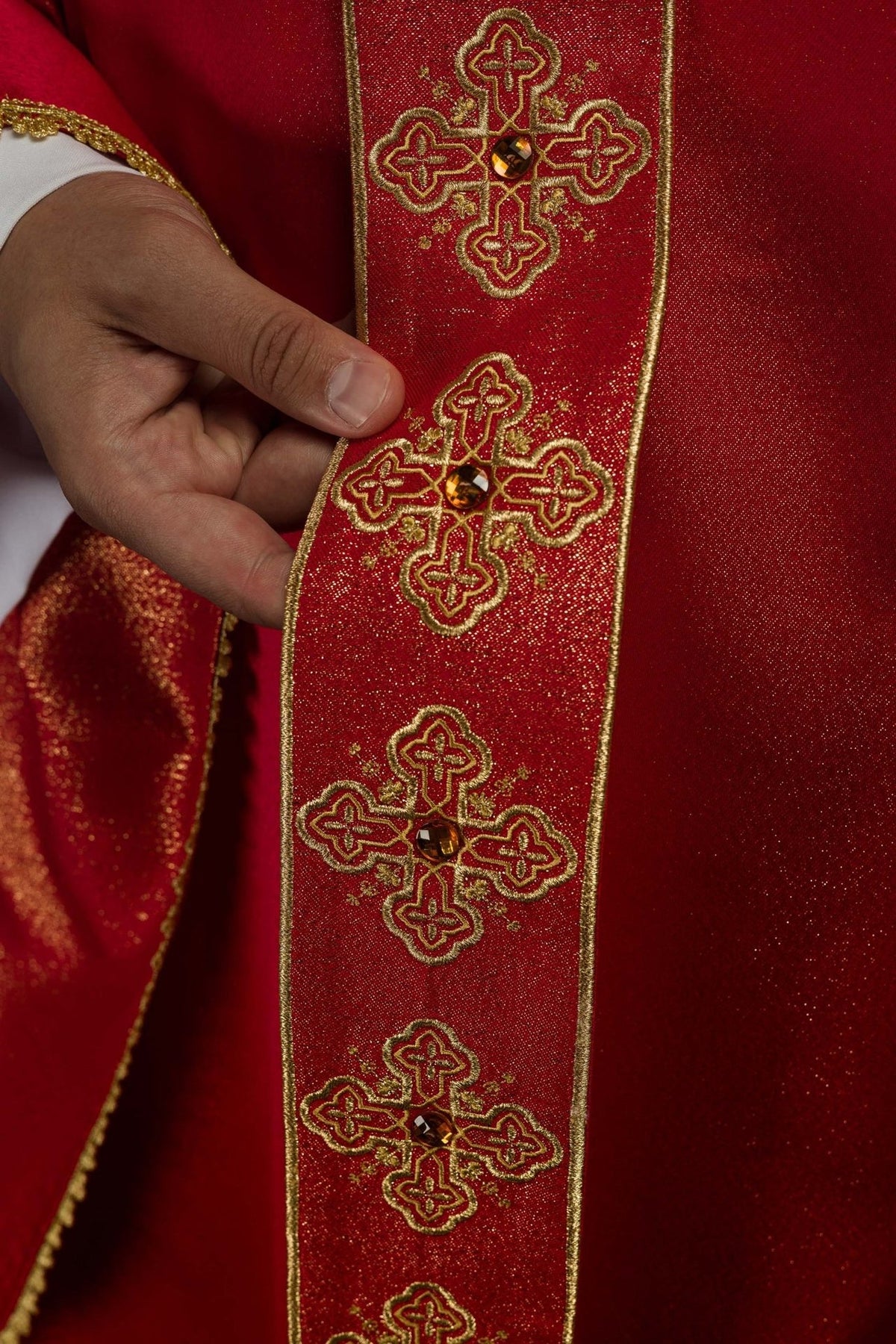 Red chasuble close-up of the embroidered orphrey with jeweled cross motifs