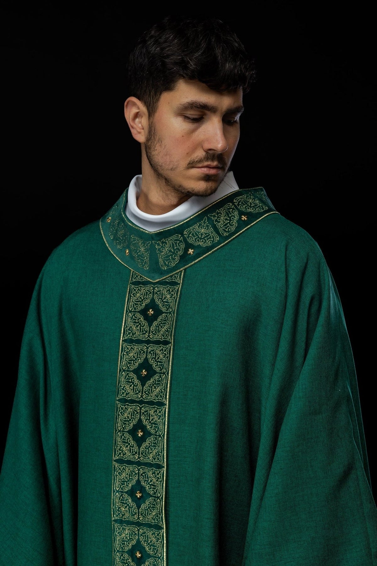Green chasuble close-up showing embroidered gold orphrey and collar