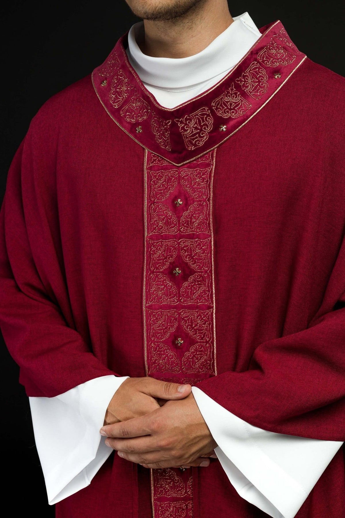 Red chasuble close-up showing the embroidered collar and central orphrey