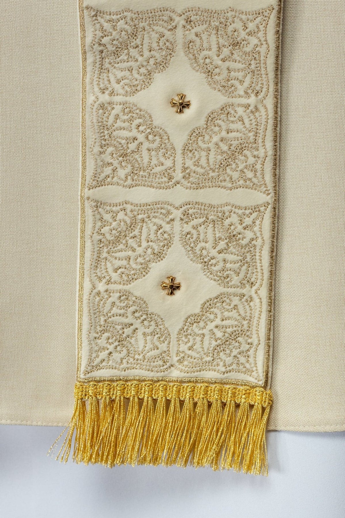 Ecru chasuble close-up with gold embroidery on the front orphrey