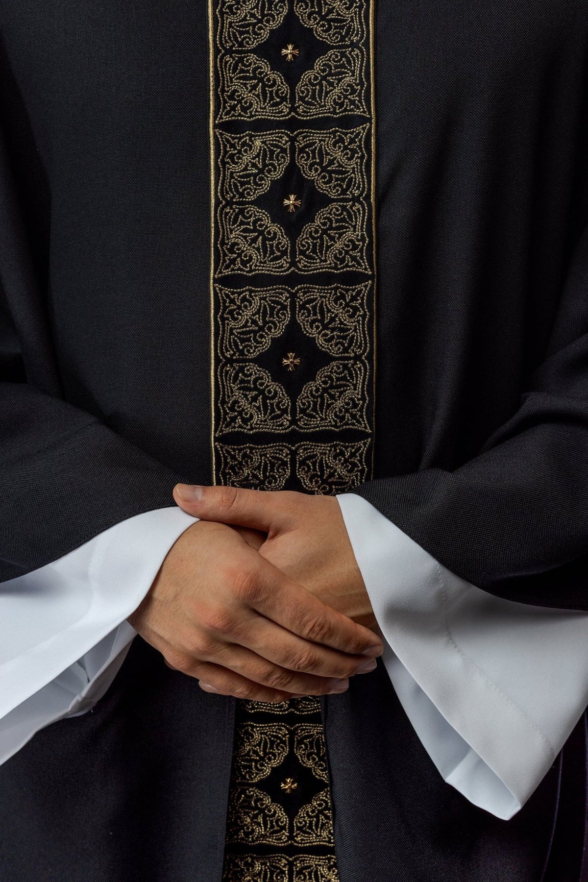 Black chasuble close-up of gold embroidered orphrey with cross motifs
