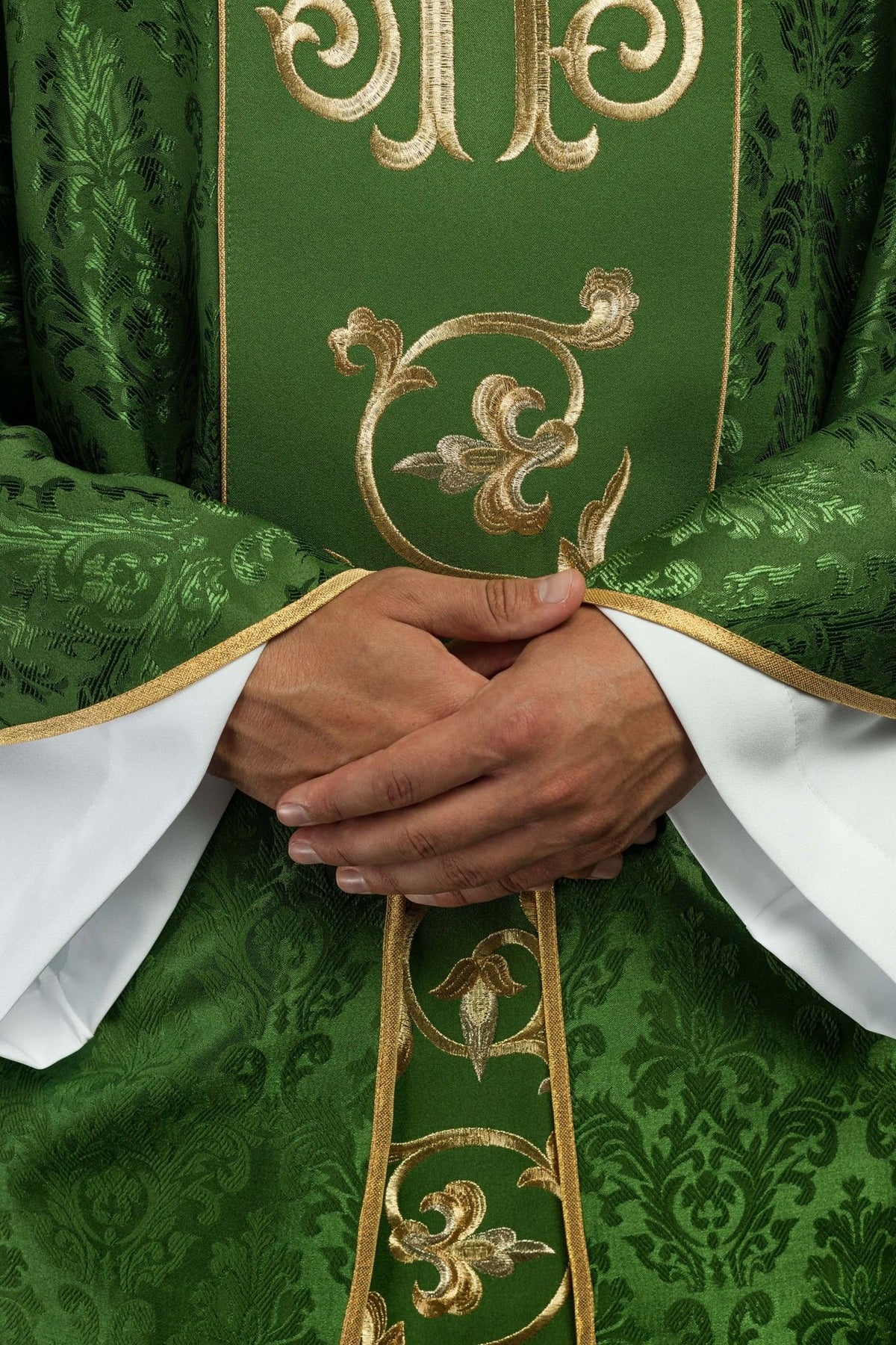 Green chasuble close-up of gold floral orphrey embroidery