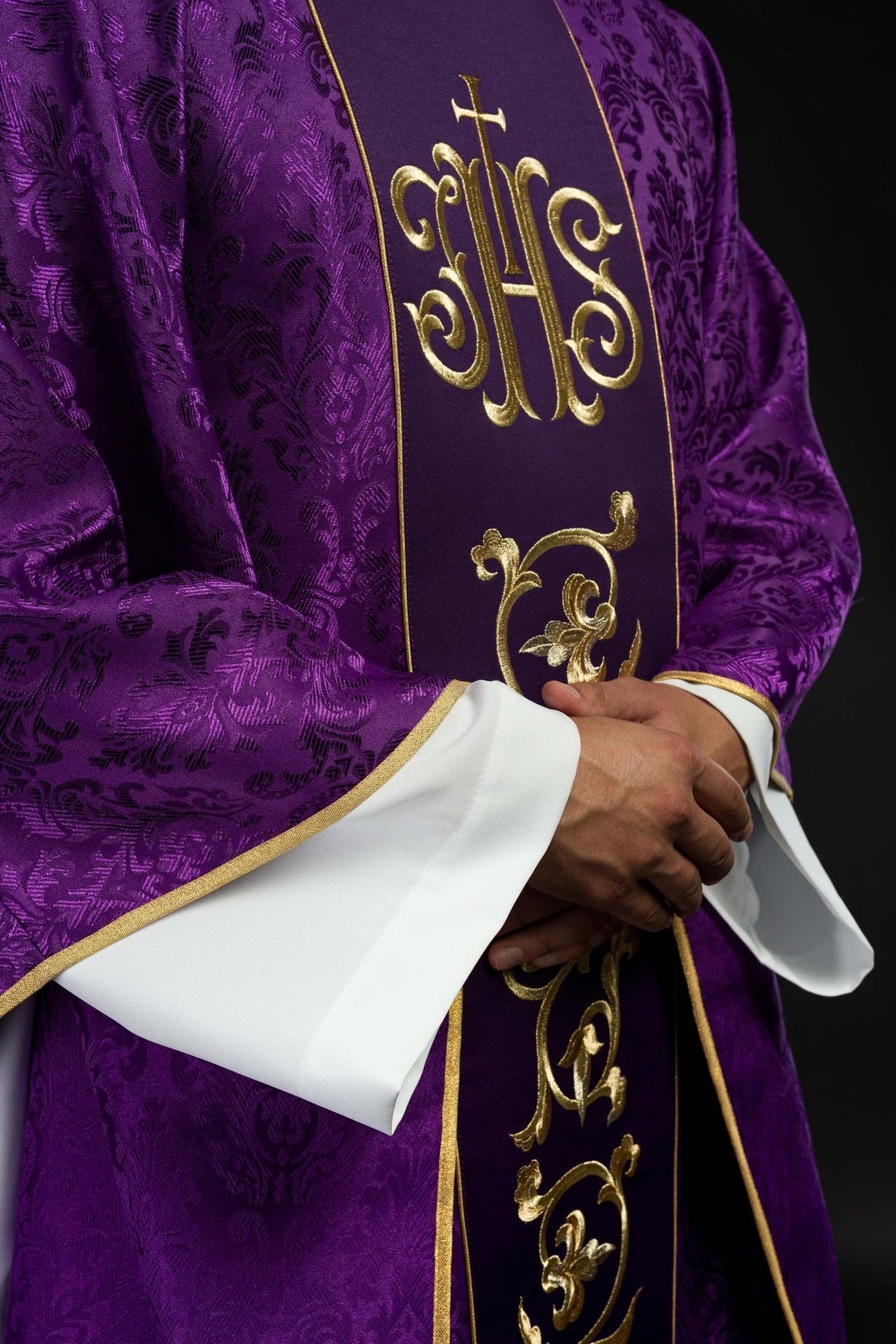 Purple chasuble angled front view with gold IHS embroidery and satin trim