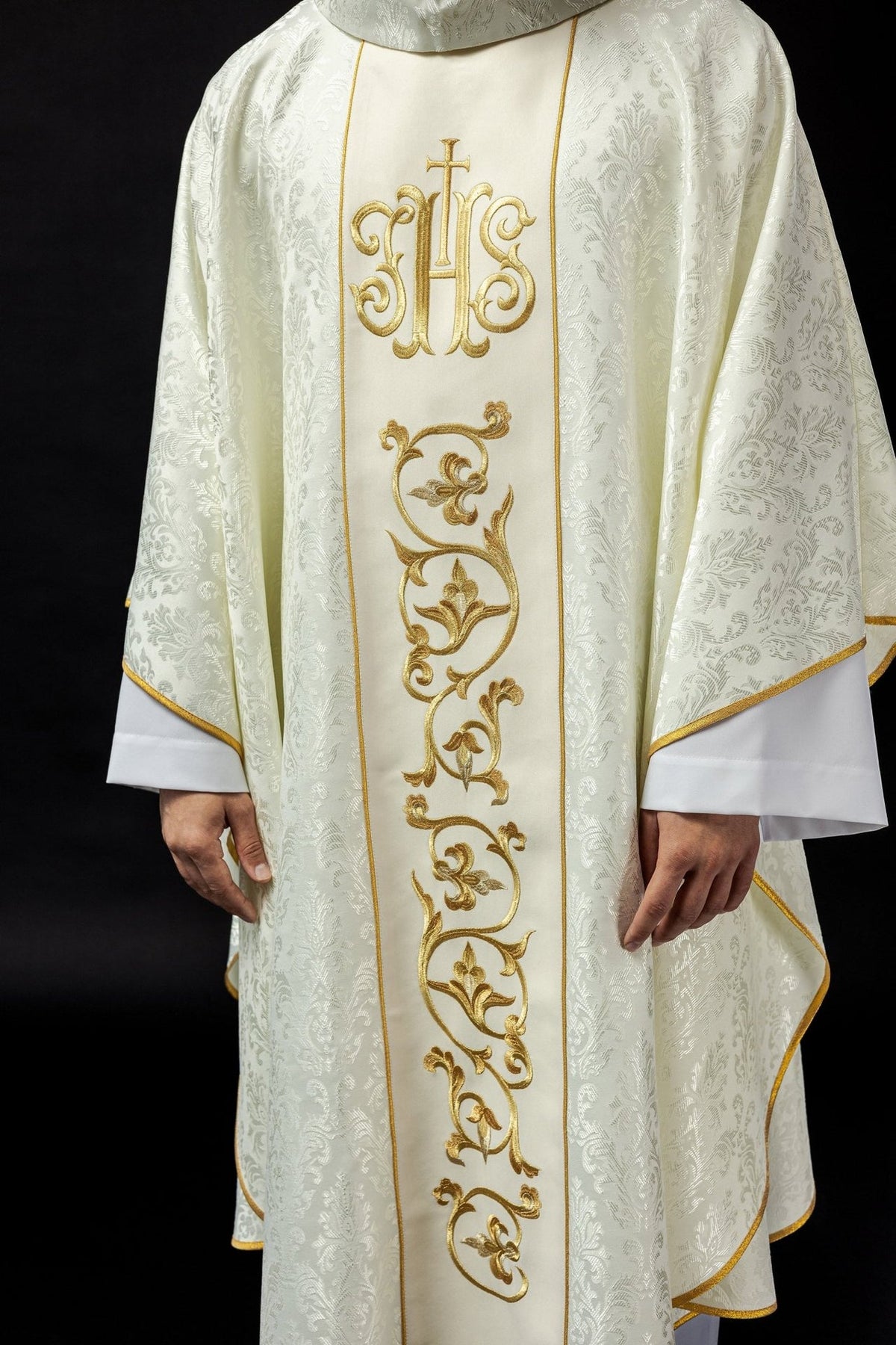 Ecru chasuble front view showing the gold IHS orphrey and floral embroidery