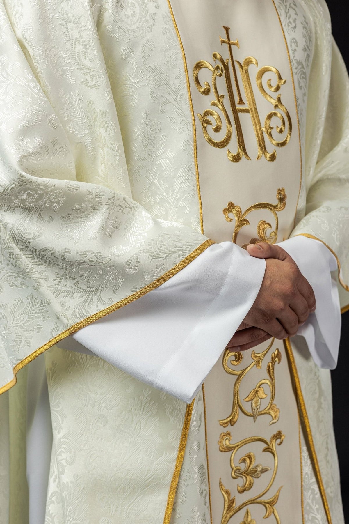 Ecru chasuble front detail with gold IHS embroidery and patterned satin fabric