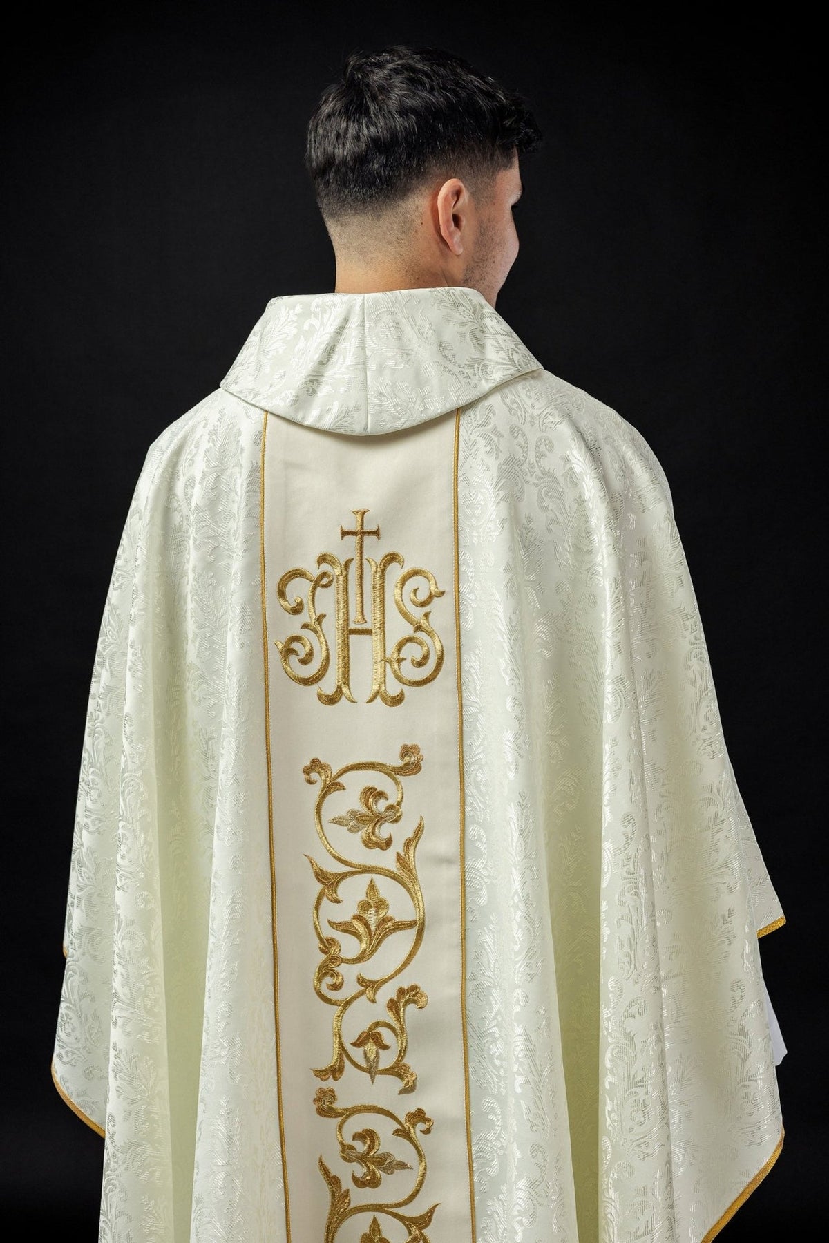 Ecru chasuble back close-up with gold IHS orphrey and patterned fabric