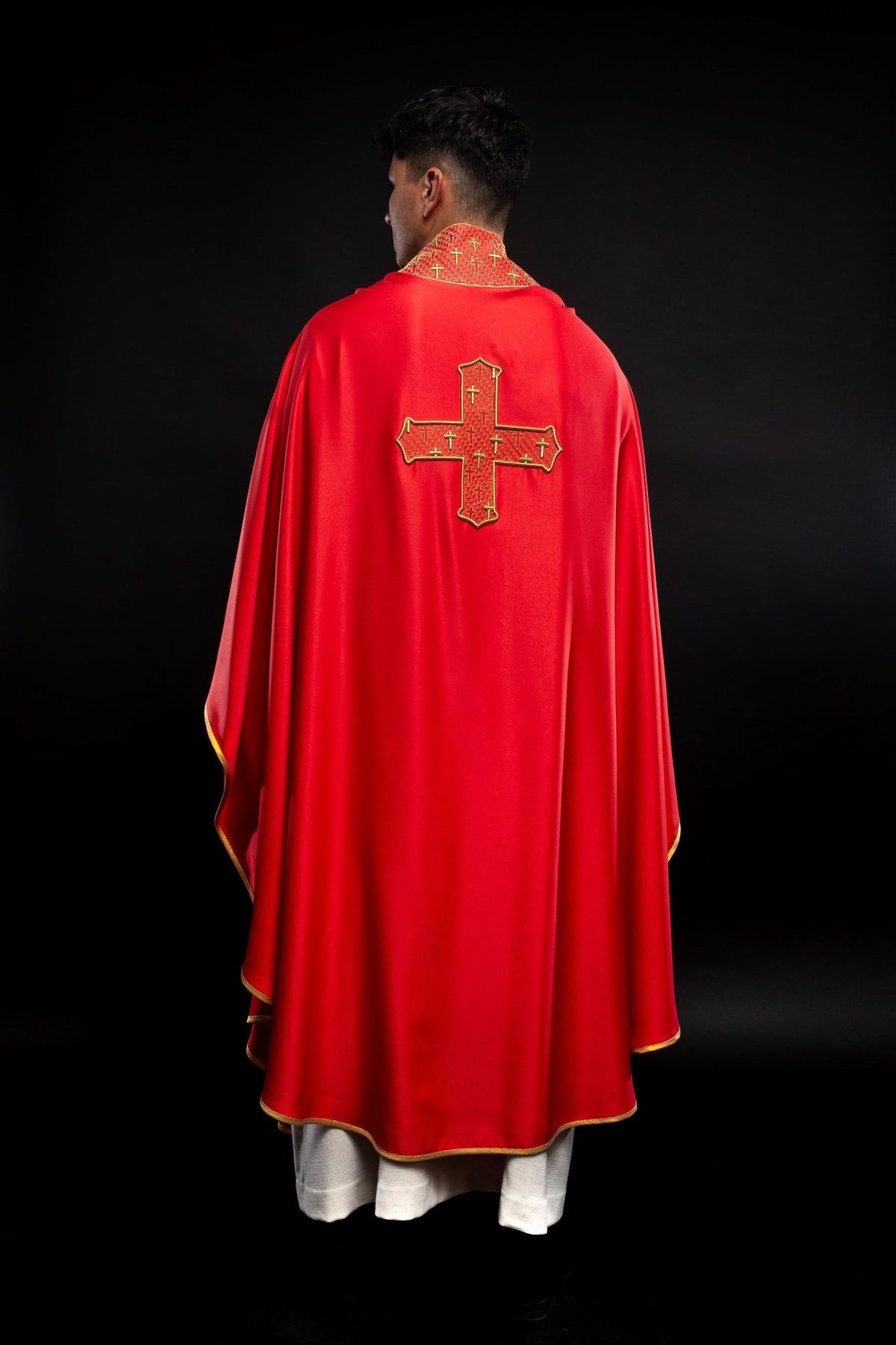 Red chasuble back view with embroidered cross and gold-trimmed collar