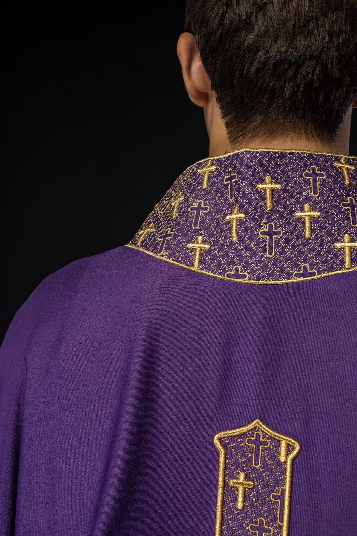 Purple chasuble back close-up with gold cross embroidery on collar