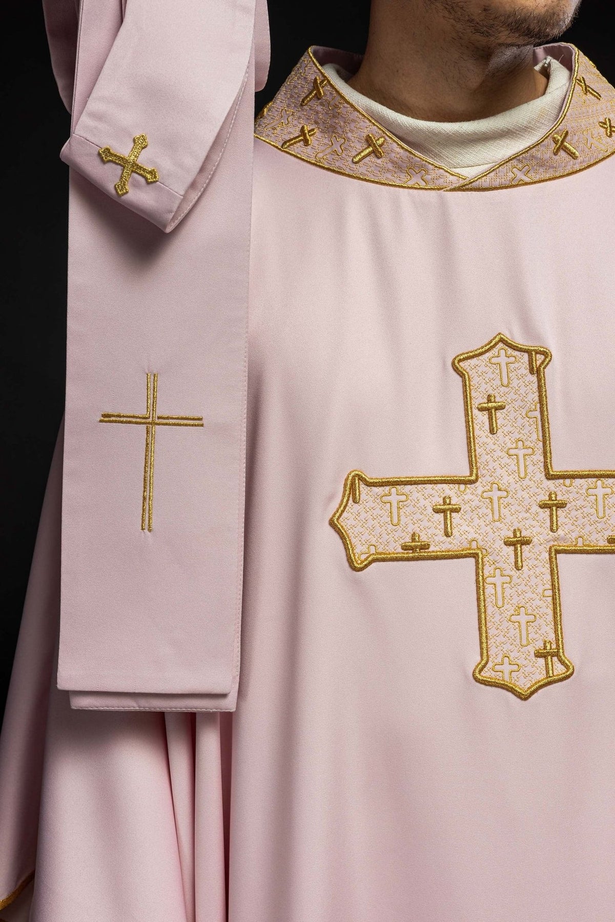 Rose chasuble side detail with gold embroidered crosses on the collar and sleeve