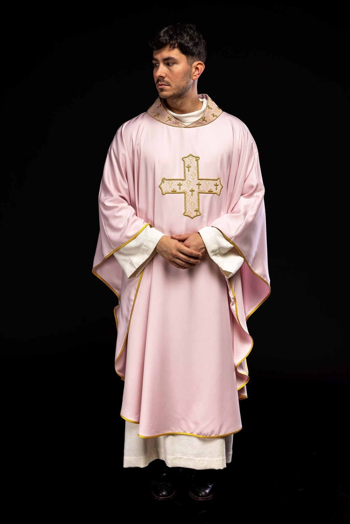 Rose chasuble worn front view with gold-trimmed sleeves and embroidered cross