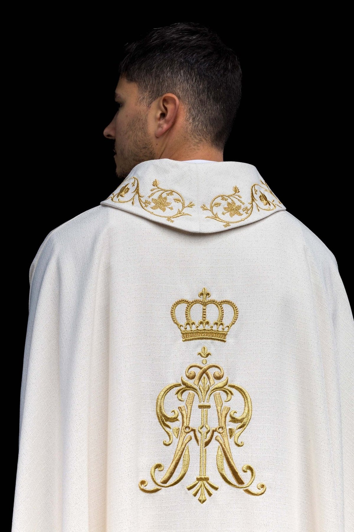 Liturgical chasuble back view with gold Marian monogram and floral collar embroidery