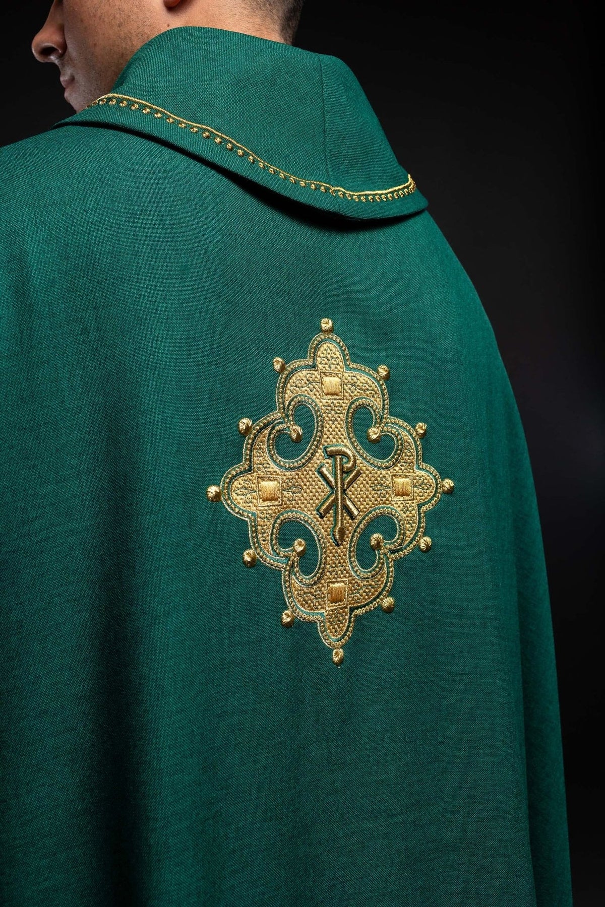Green chasuble back view with embroidered cross and gold trim