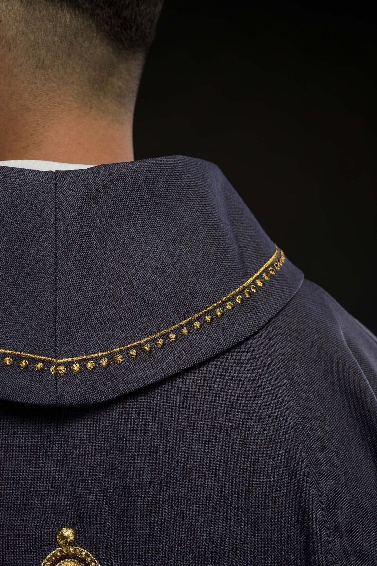 Purple chasuble back close-up with gold collar trim