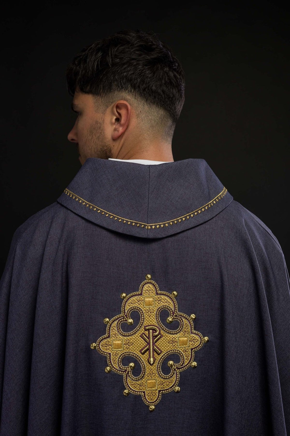 Purple chasuble back view with embroidered gold cross