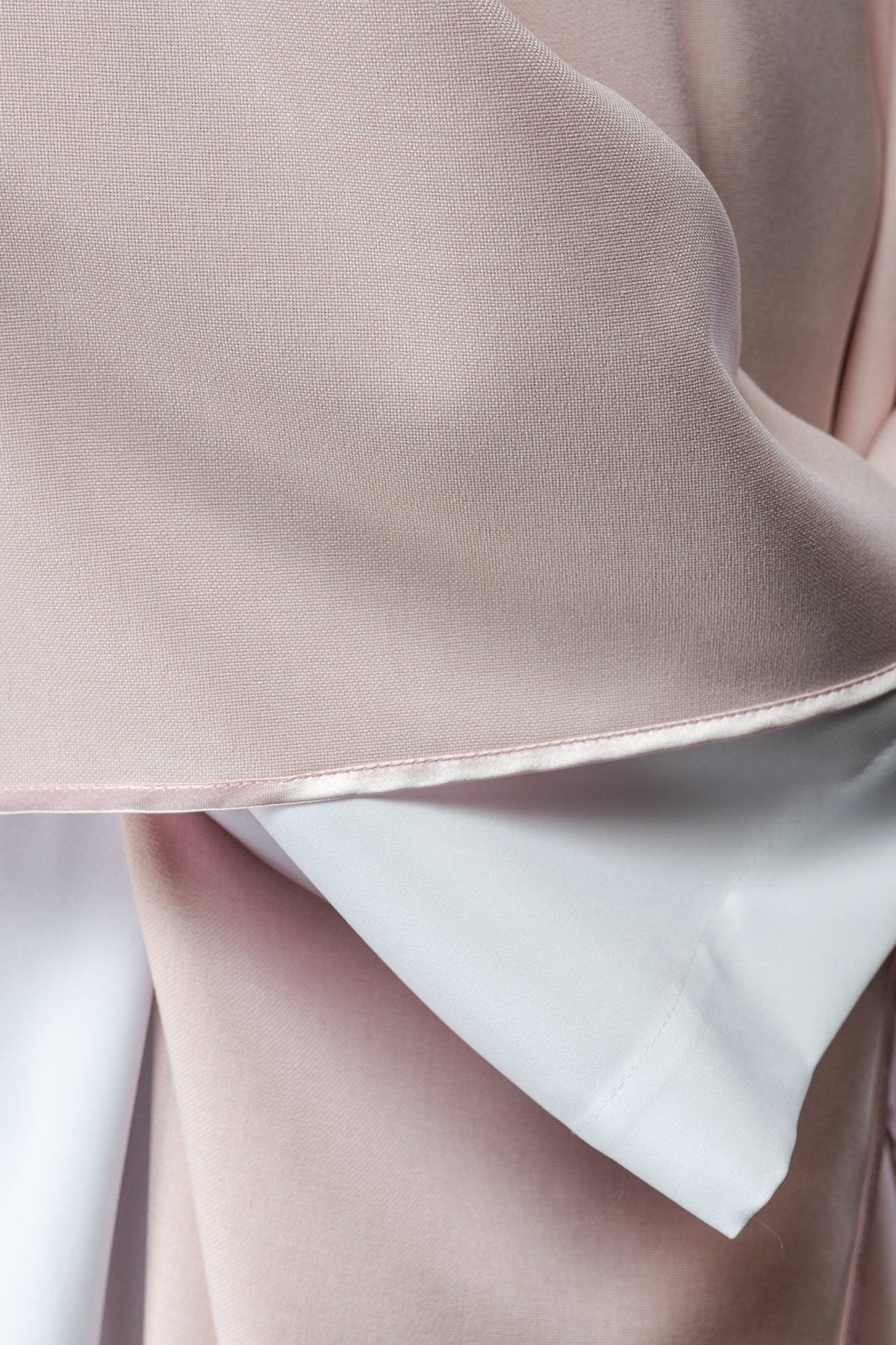 Rose chasuble close-up showing rose fabric and trimmed sleeve edge