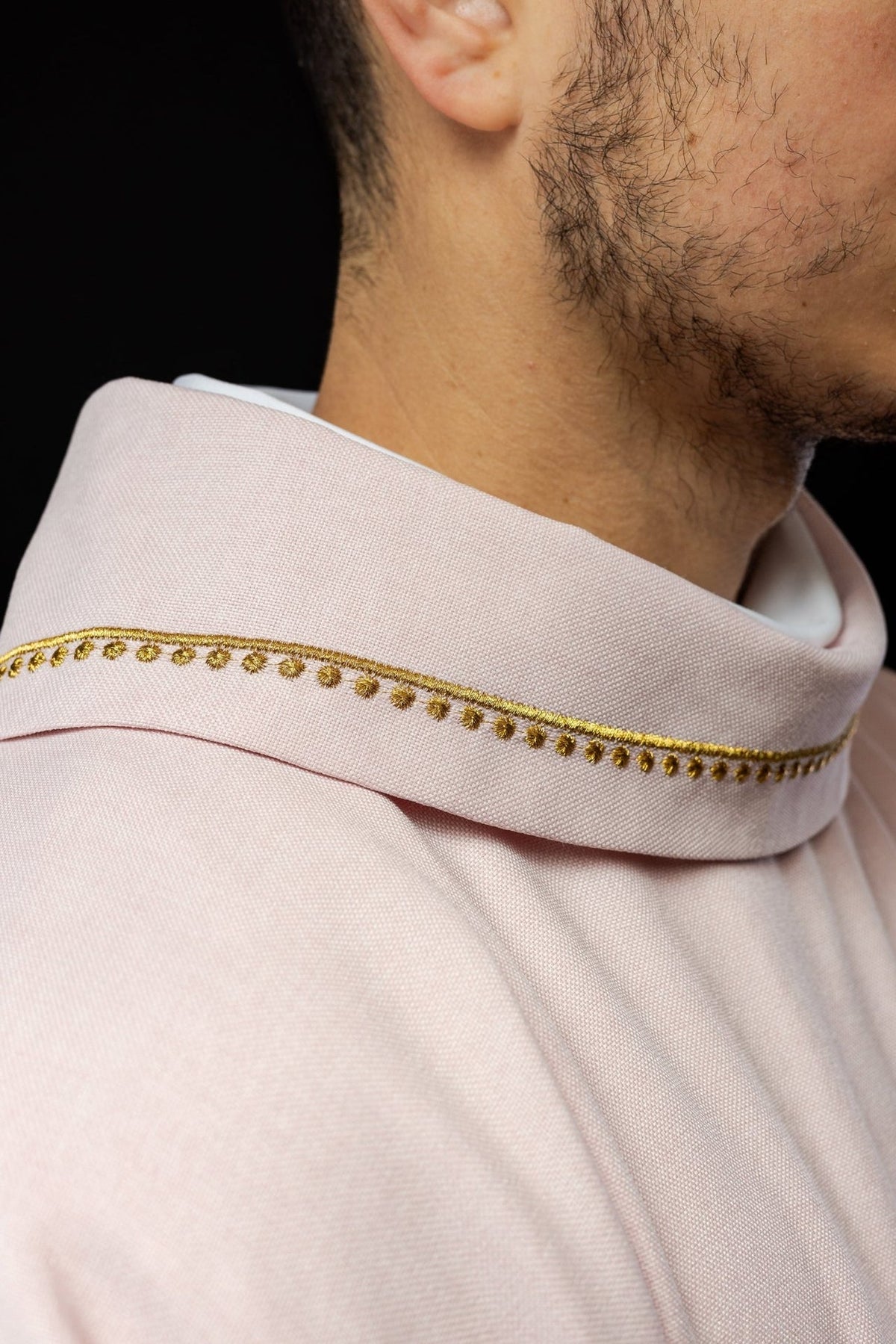 Rose chasuble close-up showing gold collar trim on rose fabric