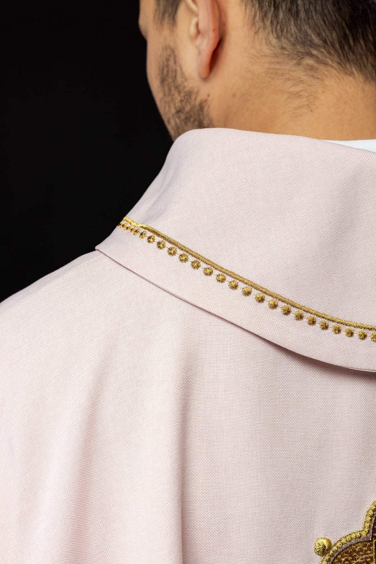 Rose chasuble back view with gold collar trim and embroidered cross