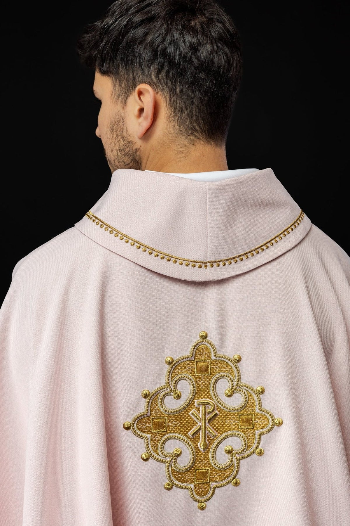 Rose chasuble rear three-quarter view with gold collar trim and cross embroidery