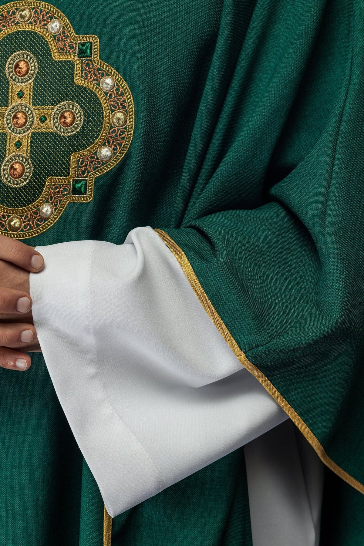 Green chasuble sleeve close-up with gold trim