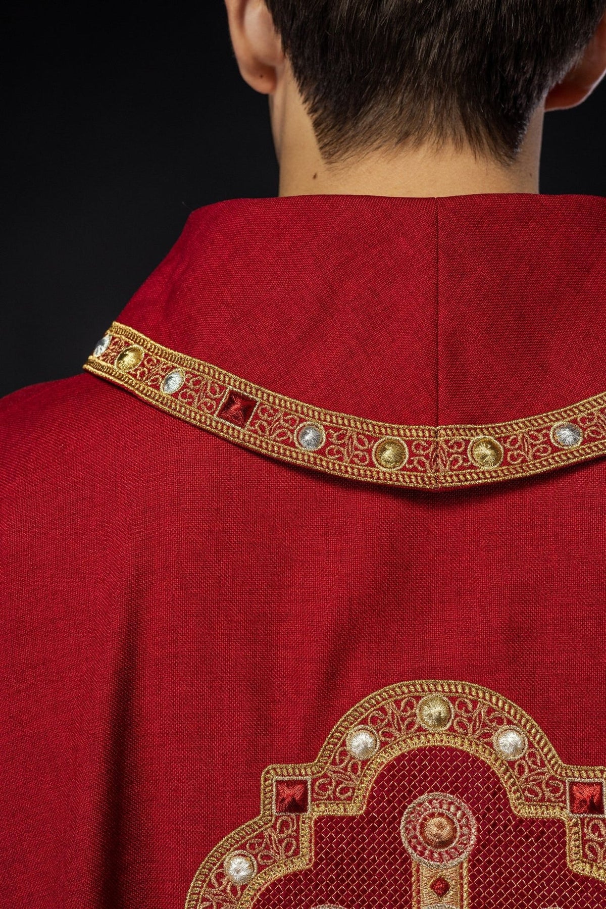 Red chasuble, back close-up showing embroidered collar trim and cross detail