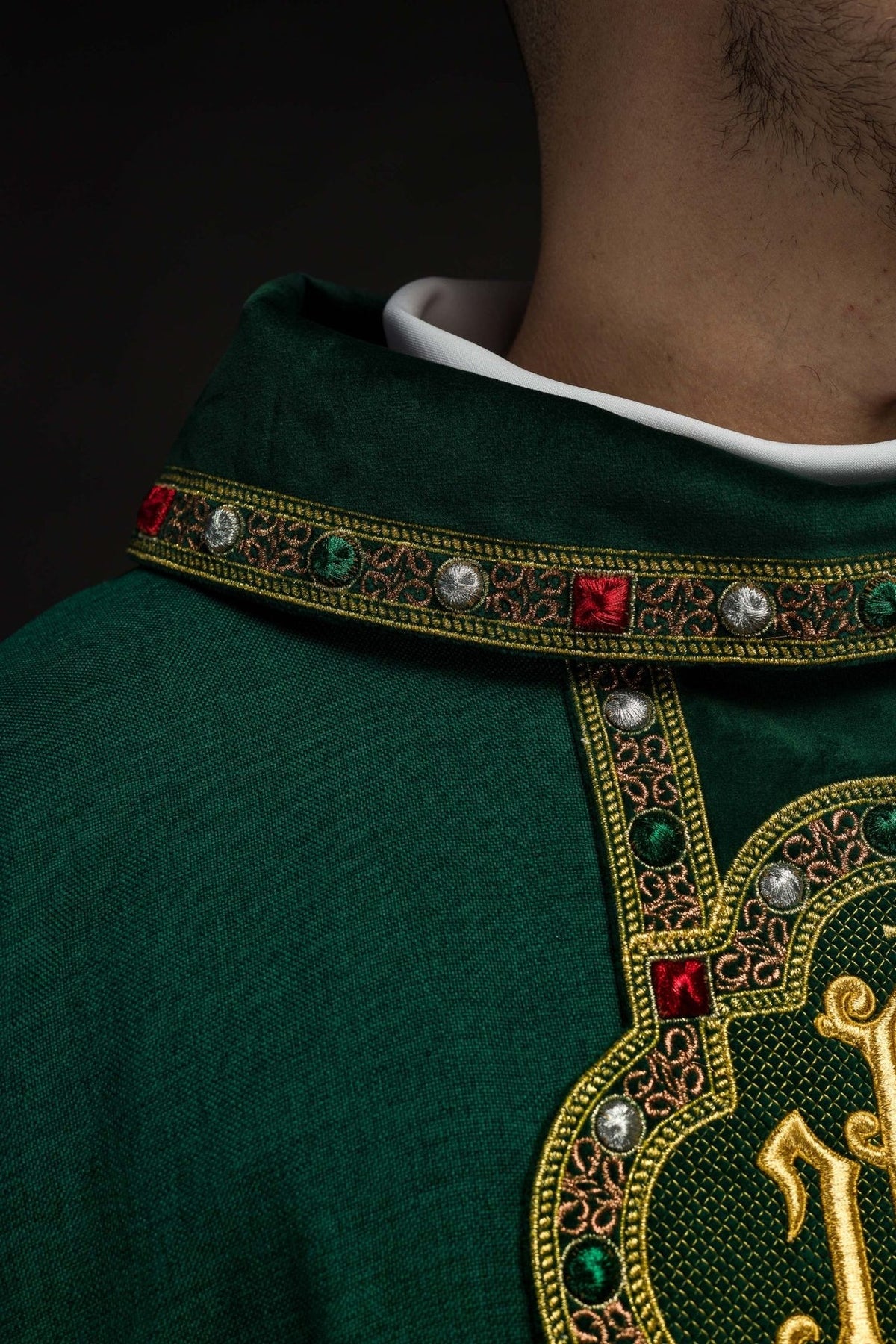 Green chasuble close-up of embroidered collar trim and IHS orphrey