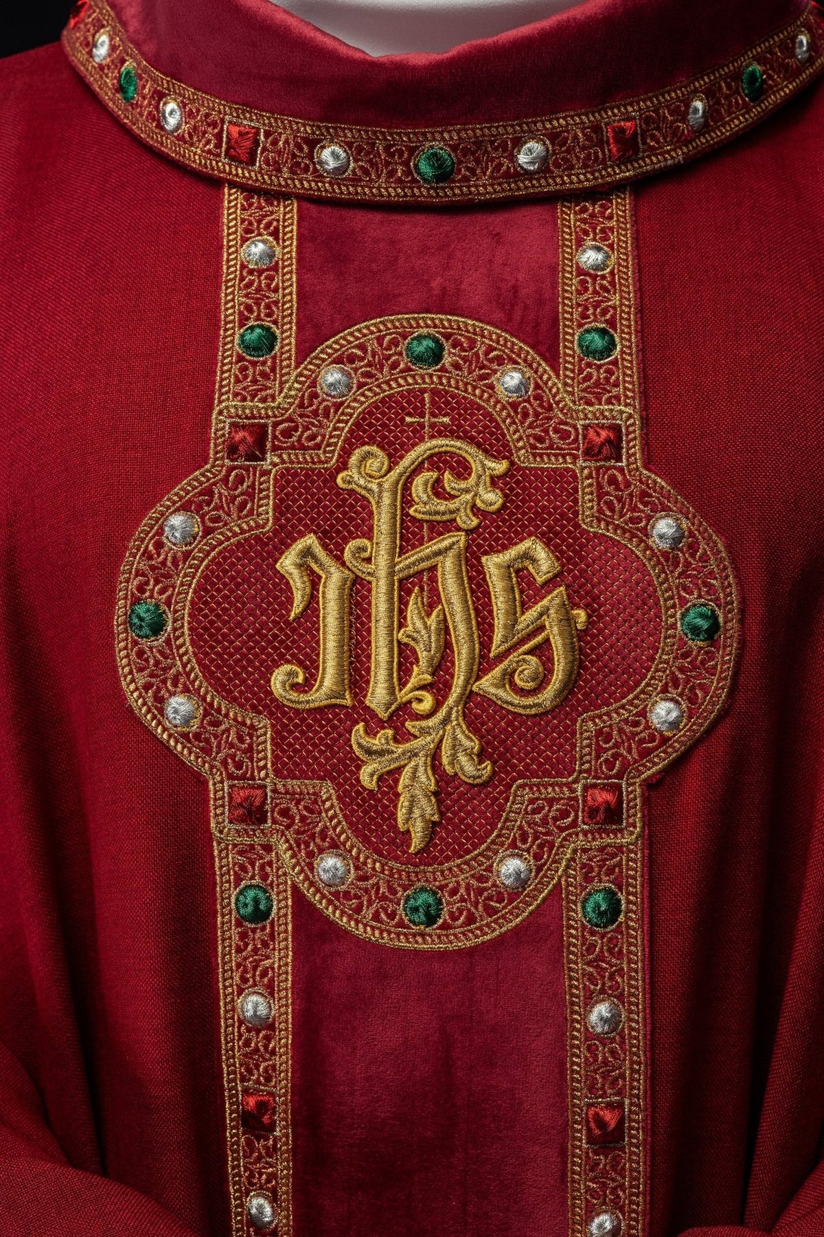 Red chasuble front close-up showing embroidered IHS and jeweled orphrey
