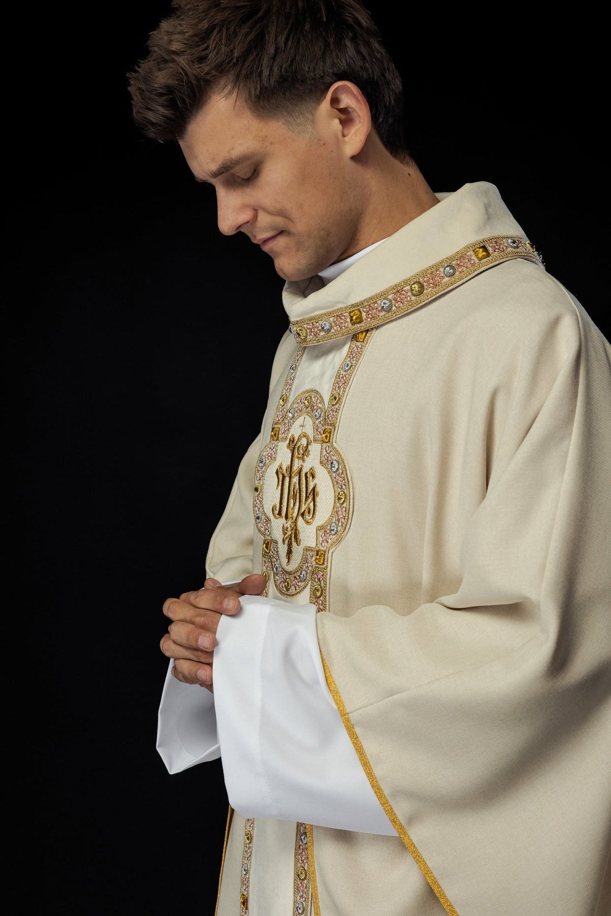 Ecru chasuble worn in side view, showing embroidered front orphrey