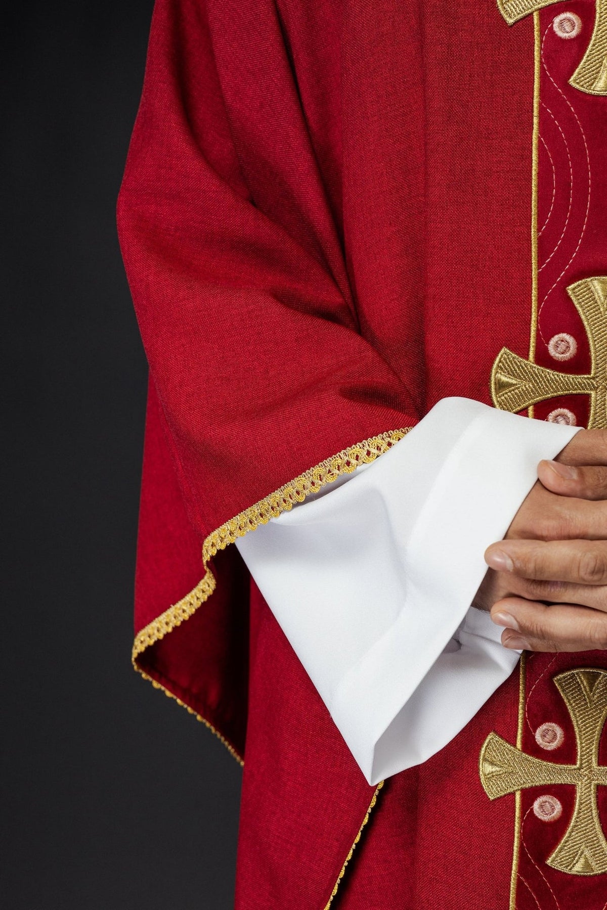Red chasuble sleeve with gold trim and cross embroidery detail