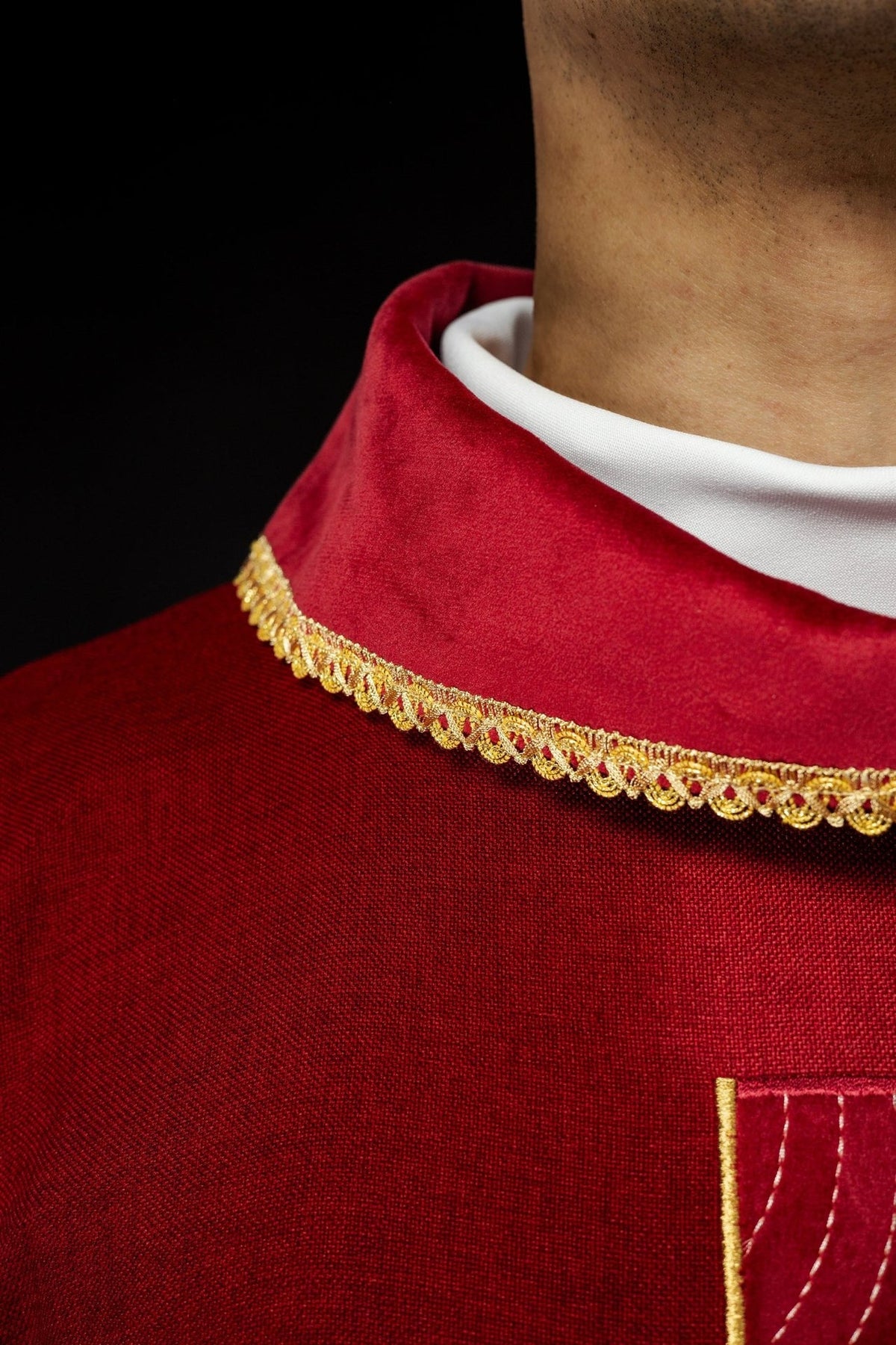 Red chasuble collar with gold trim close-up
