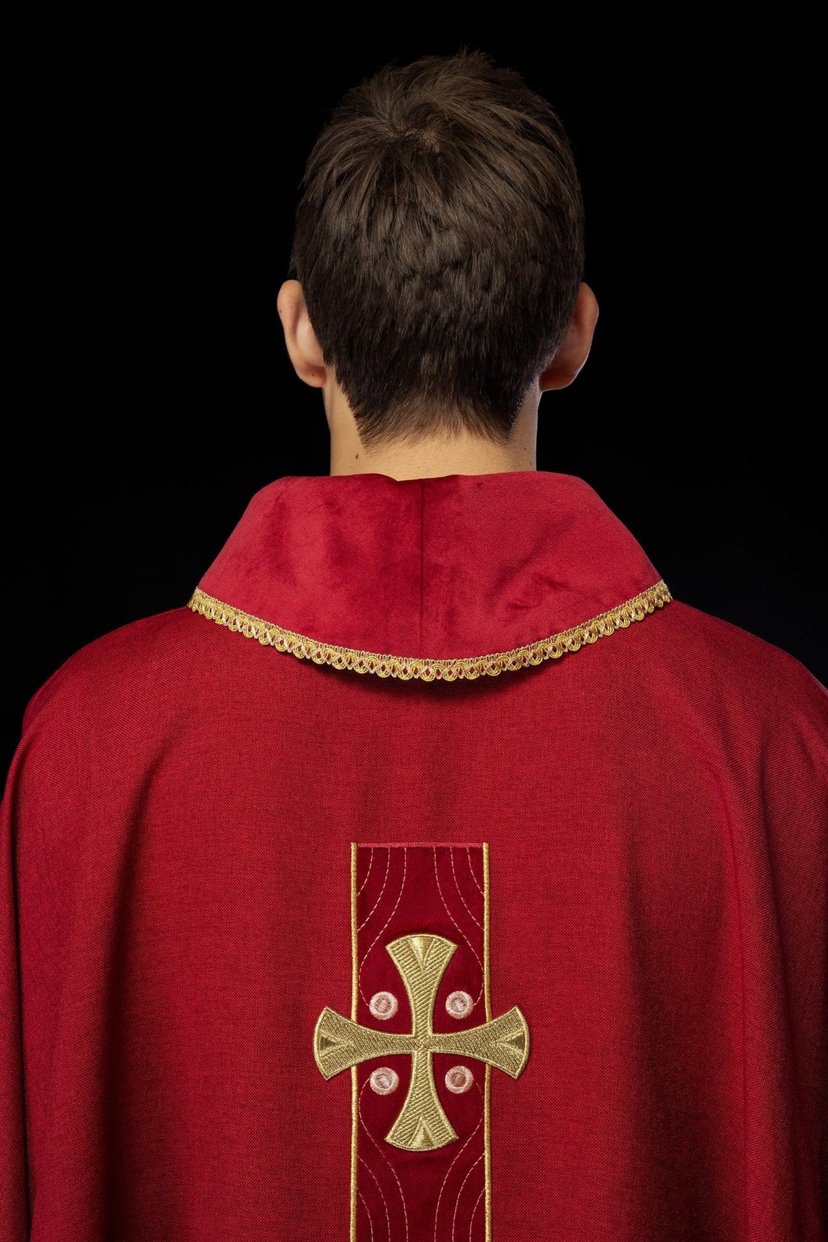 Red chasuble back with embroidered gold crosses
