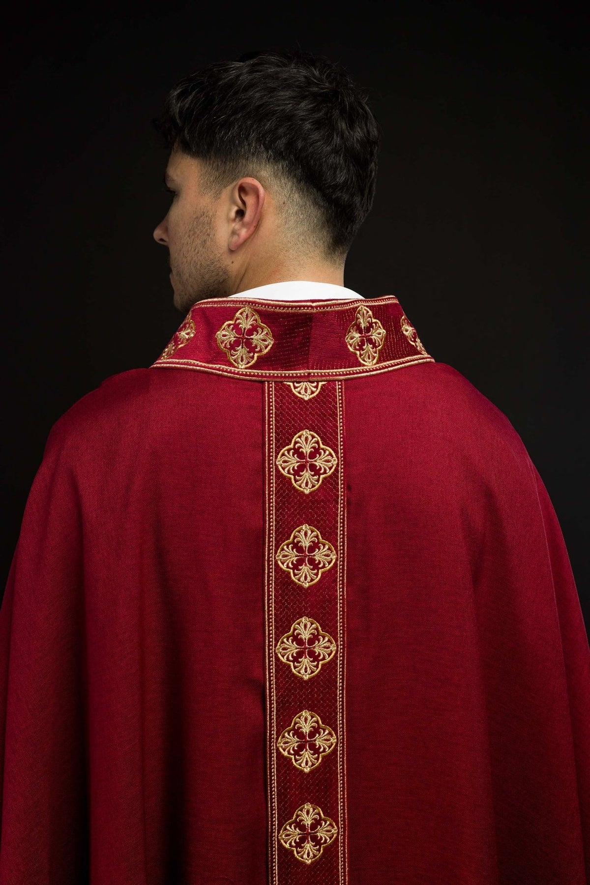Red chasuble back view with gold embroidered orphrey and collar