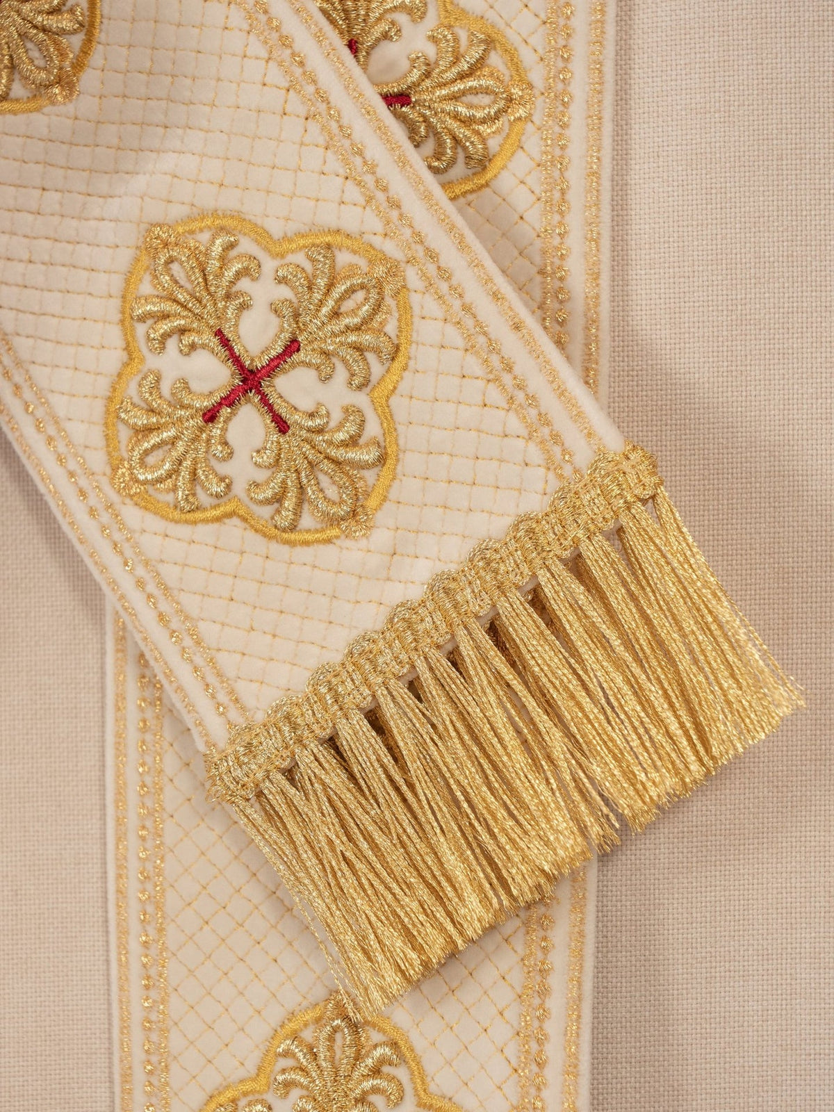 Ecru chasuble side detail showing wide sleeve and embroidered orphrey