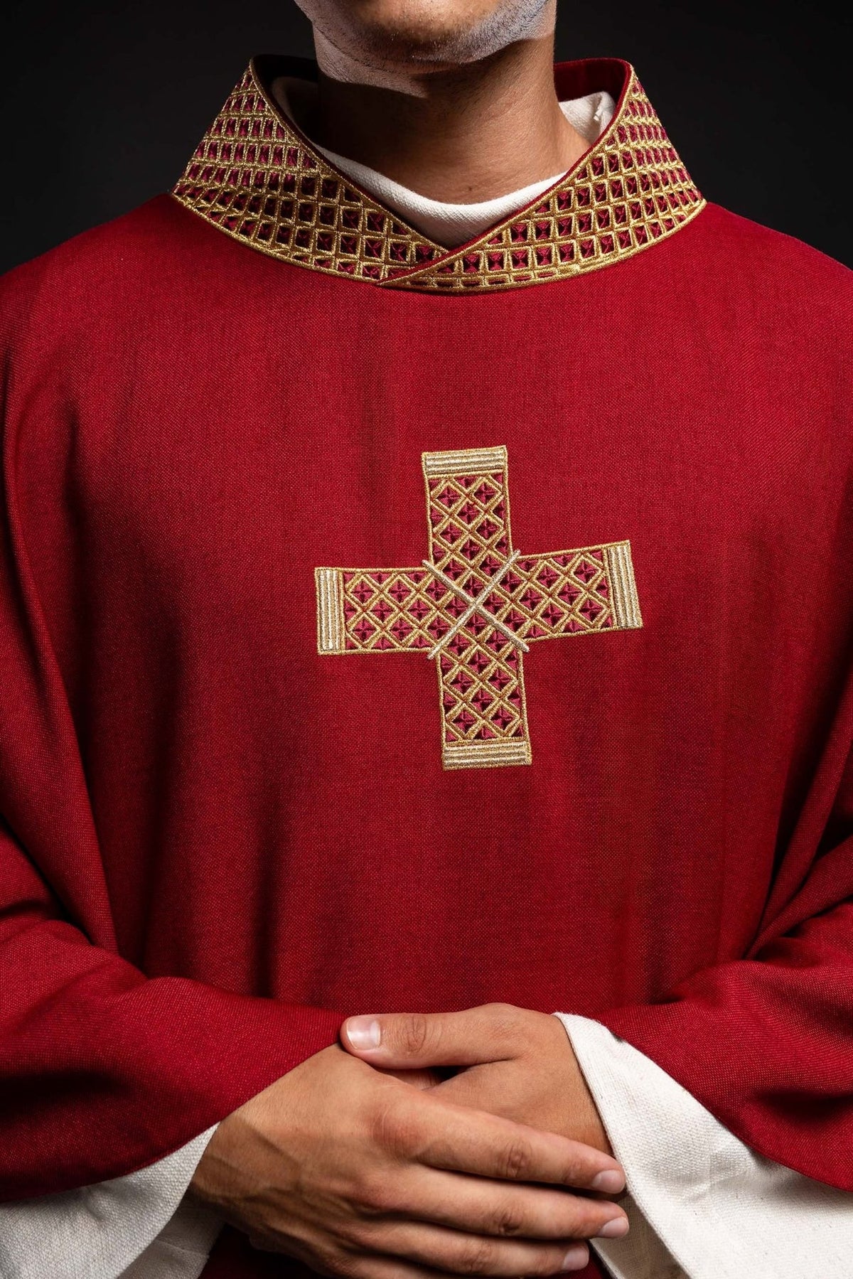 Red chasuble, close-up front view of gold embroidered cross and patterned collar
