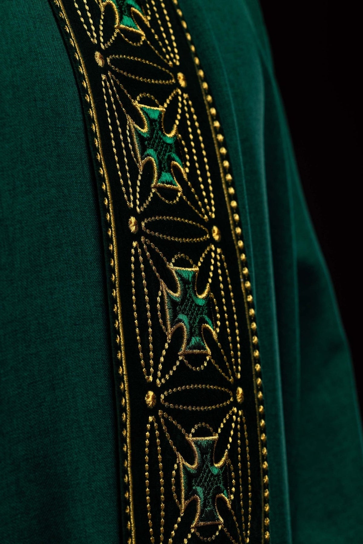 Green chasuble close-up of embroidered cross motifs on black orphrey