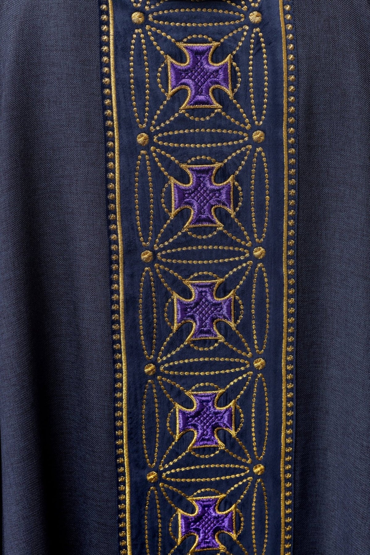 Embroidered cross orphrey detail on the purple chasuble