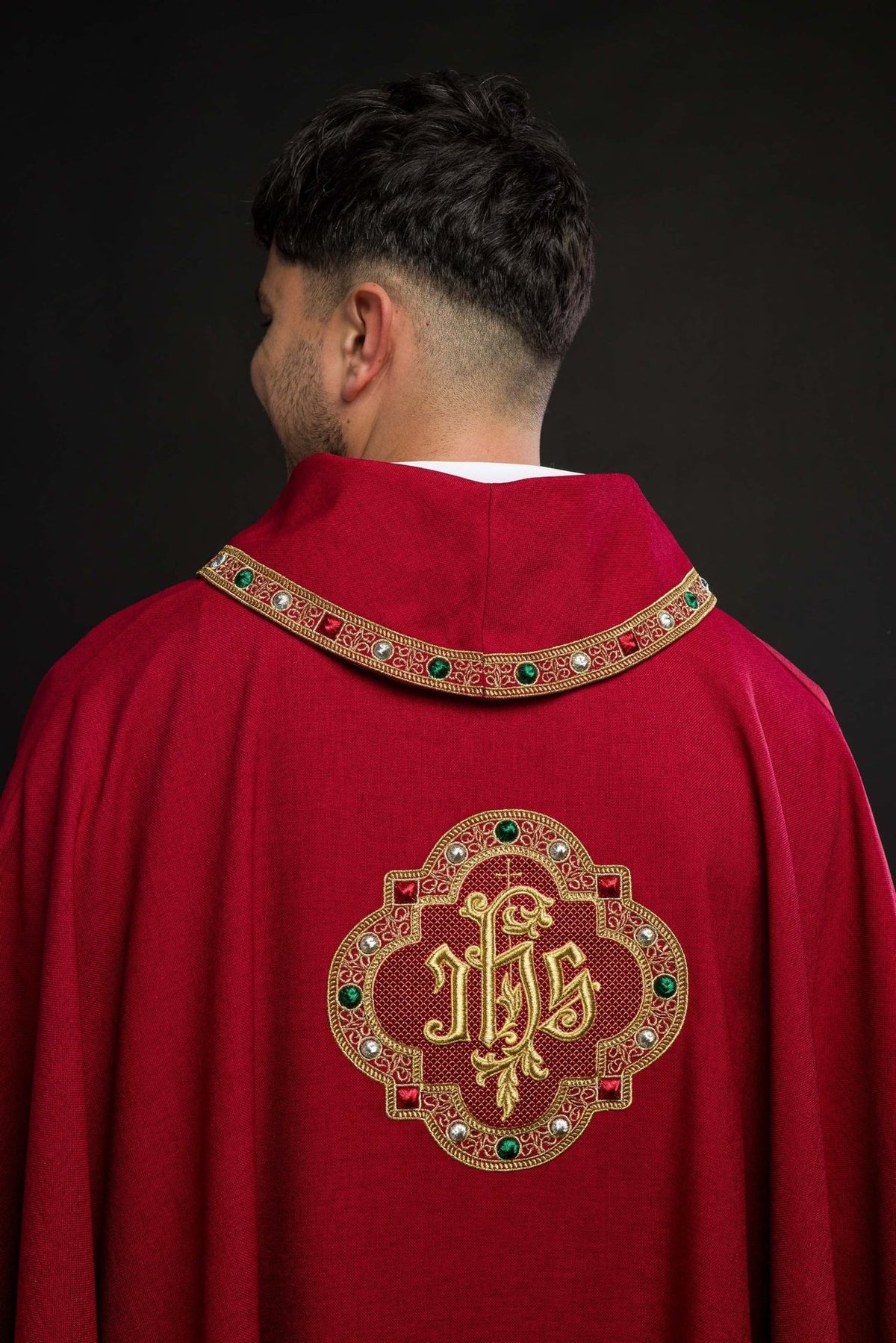 Red chasuble, back view with gold-trimmed collar and IHS embroidery