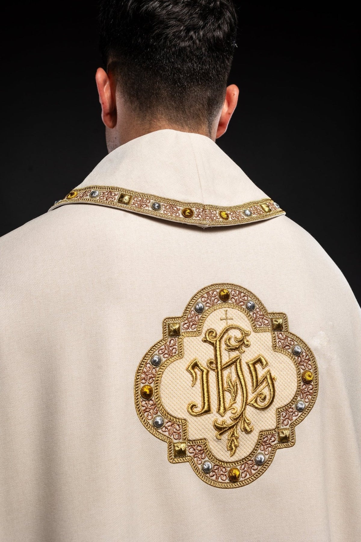 Ecru chasuble back close-up with IHS embroidery and collar trim
