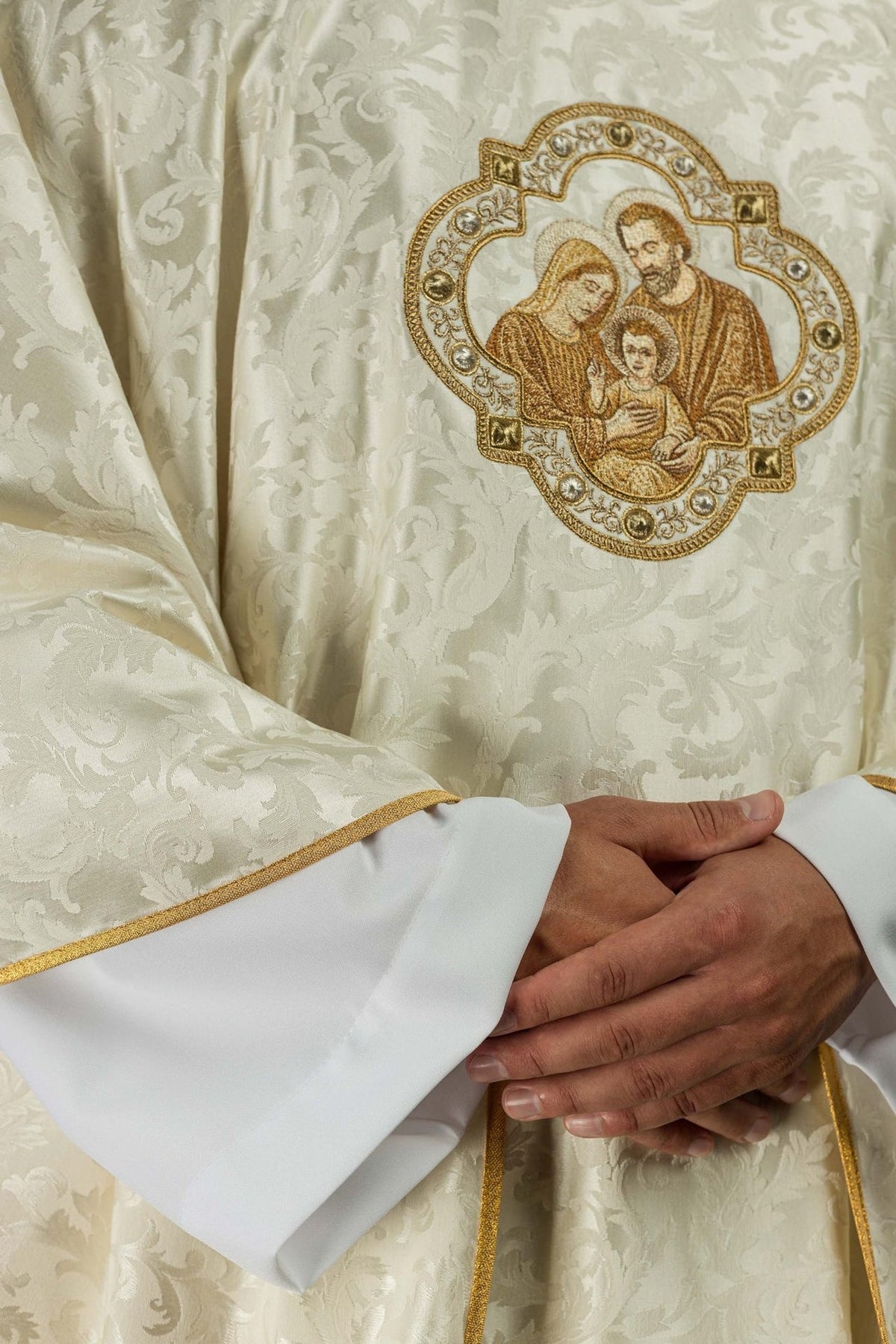 Christmas chasuble front detail with Holy Family embroidery and gold-edged sleeves