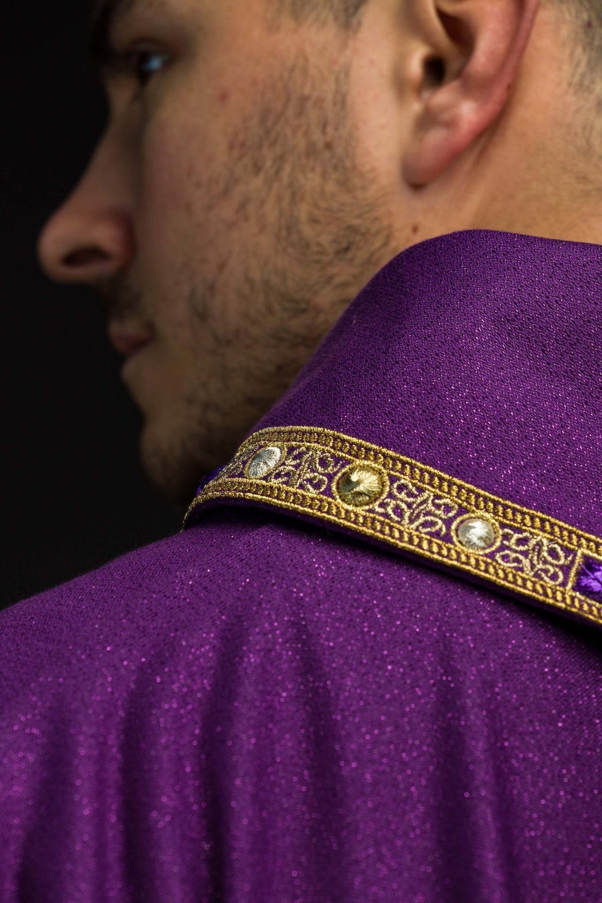 Purple chasuble close-up showing the gold embroidered stand-up collar