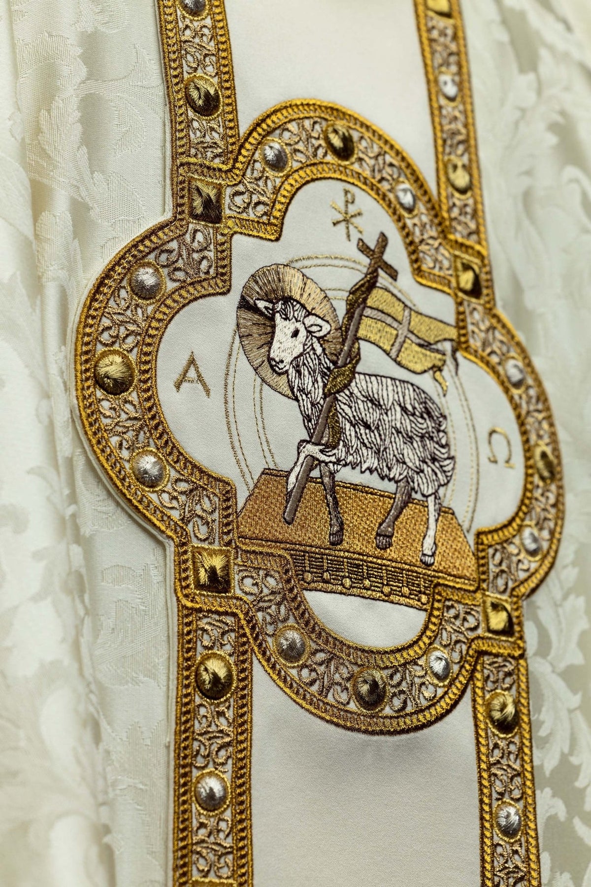 Close-up of Paschal Lamb embroidery on the ecru chasuble orphrey